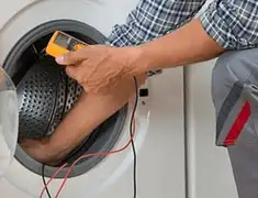 Washing machine repair technician testing a front-load washer with diagnostic tools in Tampa, FL